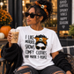 A woman wearing a white graphic t-shirt with a horror-comedy design that reads 'I LIKE MURDER SHOWS COMFY CLOTHES AND MAYBE 3 PEOPLE' next to a skull-and-orange-pattern headband, holding an iced coffee in a fall-themed outdoor setting.
