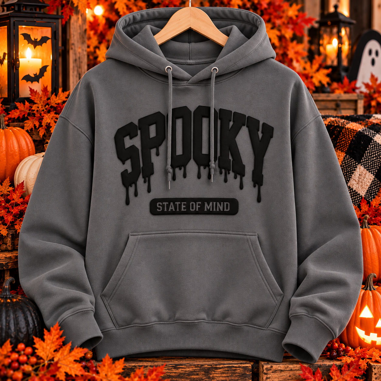 Storm gray Spooky State of Mind heavyweight pullover hoodie with raised black puff vinyl lettering on a Halloween-themed background