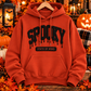 Paprika orange Spooky State of Mind heavyweight pullover hoodie with raised black puff vinyl lettering on a Halloween-themed background